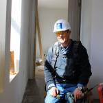Habitat volunteer Mark Morris nails in trim in one of the townhouse hallways being completed in Oak Harbor. Morris is one of a small group of volunteers who regularly help. &rdquo;Hang doors, put in floors and just building in general, that&rsquo;s what we do,&rdquo; he says. Photos by Patricia Guthrie/Whidbey News-Times