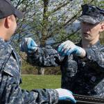 Aviation Support Equipment Technician 2nd Class Tyler Smith, right, holds up a necklace in front of Aviation Support Equipment Technician 2nd Class Ray Canafax during the annual Dumpster Dive competition as part of numerous Earth Day events at the base Friday, April 21, 2017. There also was a tree planting near the barracks at Ault Field. Photo by Ron Newberry/Whidbey News-Times