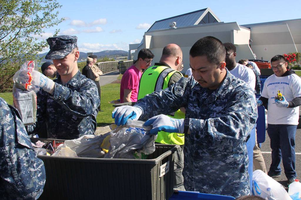Aviation Support Equipment Technician 2nd Class Tyler Smith, left, examines a loaf of moldy bread during the annual Dumpster Dive competition at NAS Whidbey Friday, April 21, 2017. Photo by Ron Newberry/Whidbey News-Times