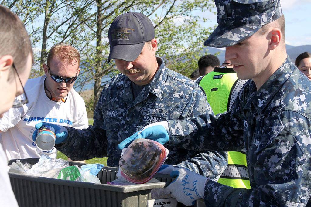 Sailors Jeffrey Rufin, left, Ray Canafax, center, and Tyler Smith represent the Fleet Readiness Center Northwest team during the annual Dumpster Dive competition at Naval Air Station Whidbey Island Friday, April 21, 2017. Photo by Ron Newberry/Whidbey News-Times