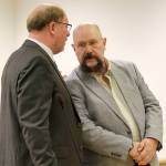 Former Island County corrections deputy Mark Moffitt speaks to his attorney, Craig Platt, in court Monday. Moffitt is facing a gross misdemeanor charge for allegedly falsifying a jail log after the death an inmate.