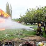Photo by Jessie Stensland / Whidbey News-Times                                Firefighters practice putting out a fire at a practice burn on the west side of Oak Harbor last weekend.