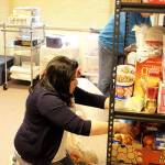 Shawna Pinder, manager of the Haven shelter, sorts out food and other supplies before guests start arriving at Christian Reformed Church fellowship hall Tuesday evening. Photo by Patricia Guthrie/Whidbey News-Times