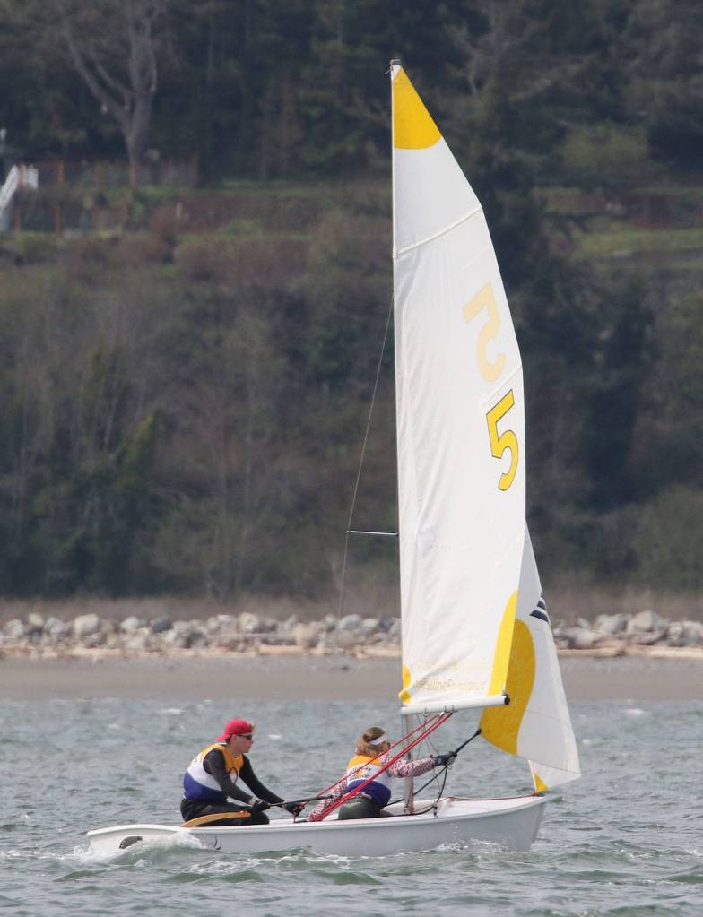 Austin Hauser (red cap) and Jenny Danielson race for the Wildcats. (Photo by John Fisken)