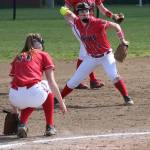 Third baseman Lauren Rose makes a play while pitcher Katrina McGranahan ducks out of the way. (Photo by Jim Waller/Whidbey News-Times)