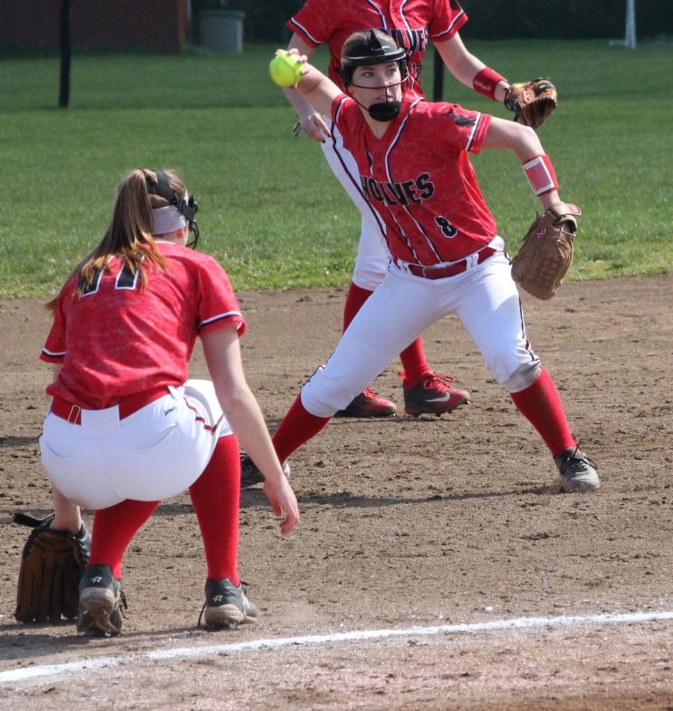 Third baseman Lauren Rose makes a play while pitcher Katrina McGranahan ducks out of the way. (Photo by Jim Waller/Whidbey News-Times)