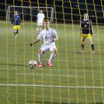 Spencer Champion (pink shoes) watches as his penalty kick heads toward the net for a goal. Everett goalkeeper Jose Neri-Guzman (feet showing on the far right) guessed wrong and dove the opposite direction of Champion&rsquo;s shot. (Photo by Jim Waller/Whidbey News-Times)
