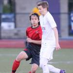 Jose Coe heads the ball for Oak Harbor. (Photo by John Fisken)