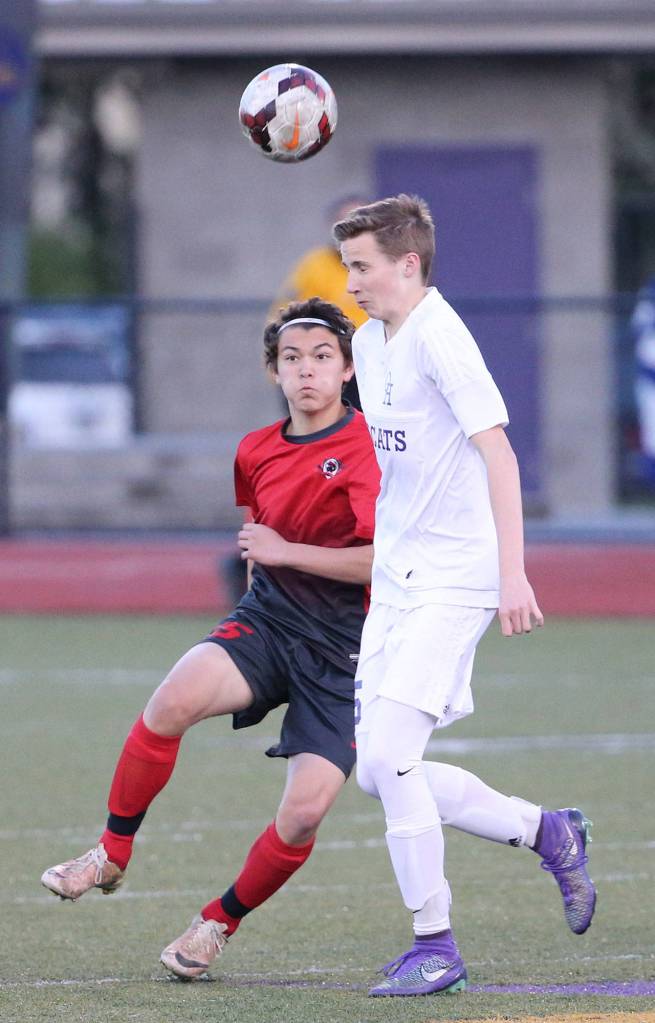 Jose Coe heads the ball for Oak Harbor. (Photo by John Fisken)