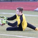 Jared Hoyt stops a Stanwood shot. (Photo by John Fisken)