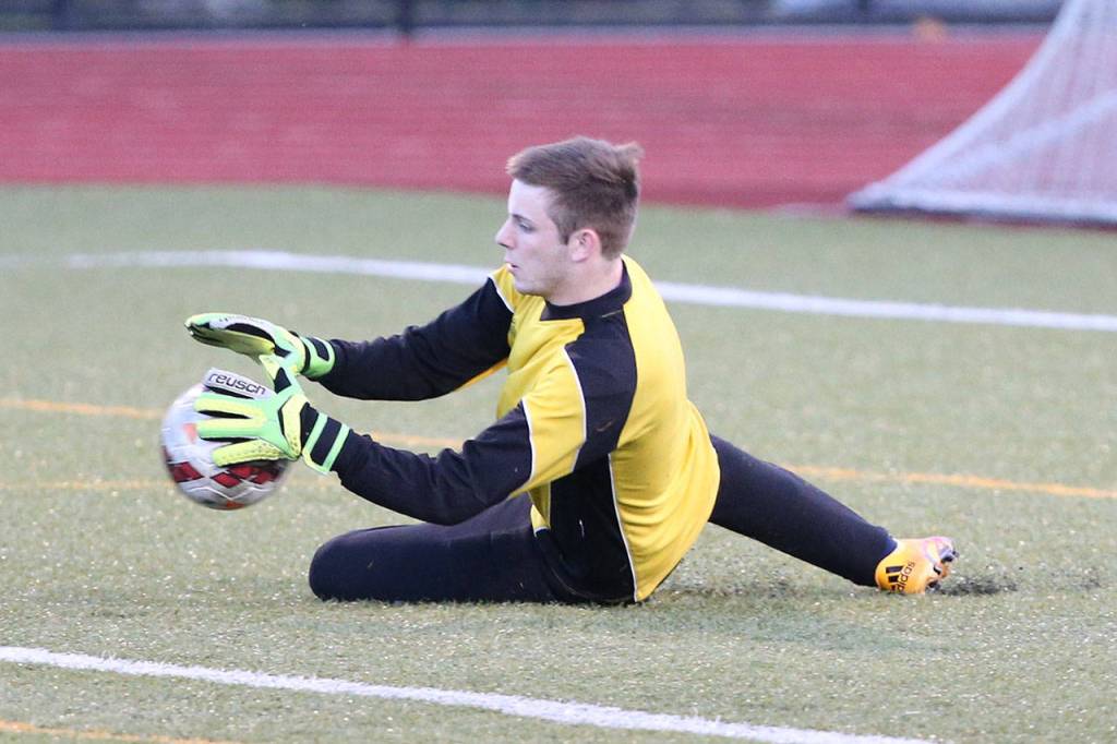 Jared Hoyt stops a Stanwood shot. (Photo by John Fisken)