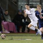 JJ Mitchell out races Meadowdale&rsquo;s David Parks to the ball. (Photo by John Fisken)