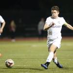JJ Mitchell, who scored three goals in the match, punches the ball forward. (Photo by John Fisken)