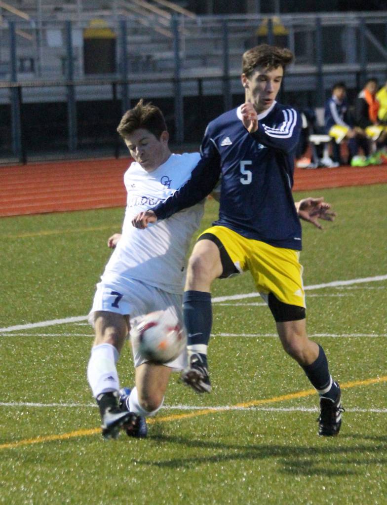 Oak Harbor&rsquo;s JJ Mitchell, left, battles Everett&rsquo;s Elijah Baer for control. (Photo by Jim Waller/Whidbey News-Times)