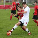 Coupeville&rsquo;s William Nelson beats Port Townsend&rsquo;s Ben Mattern to the ball. (Photo by John Fisken)