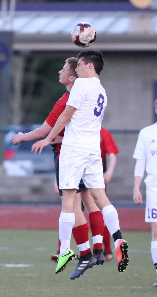 Enrique Perez-Herranz outjumps a Stanwood player to get his head on the ball. (Photo by John Fisken)