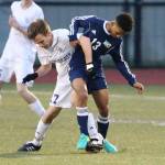 Kegan Snell fights for possession with Meadowdale&rsquo;s Zach Smith (13). (Photo by John Fisken)