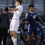 Kegan Snell out jumps Meadowdale&rsquo;s Alejandro Mejia-Segura. (Photo by John Fisken)