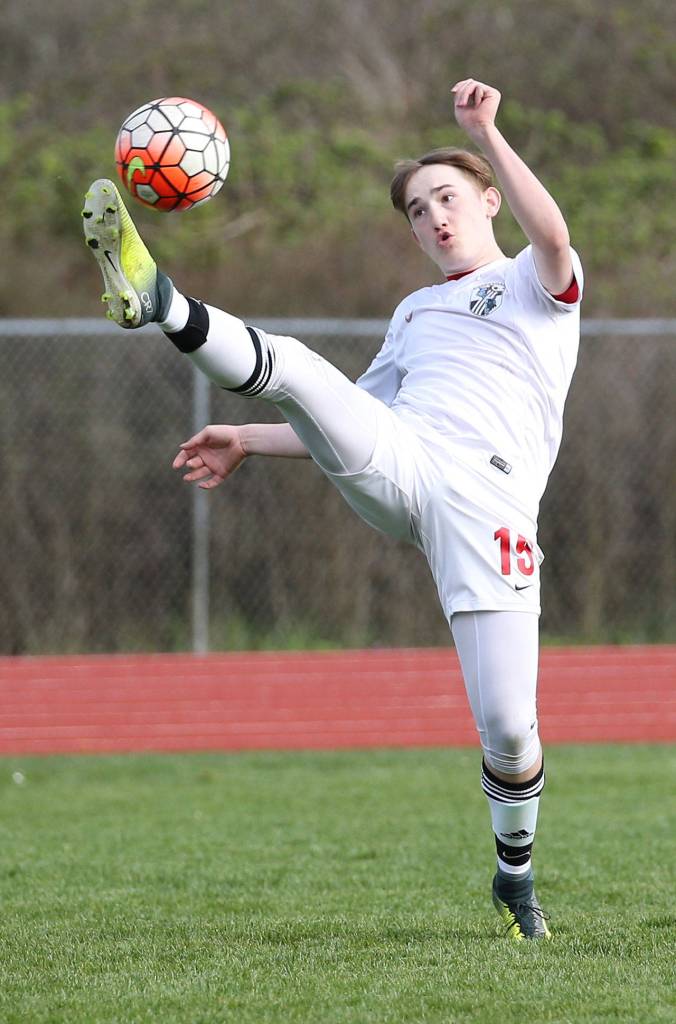 Ethan Spark reaches to boot the ball in Friday&rsquo;s match with Port Townsend. (Photo by John Fisken)