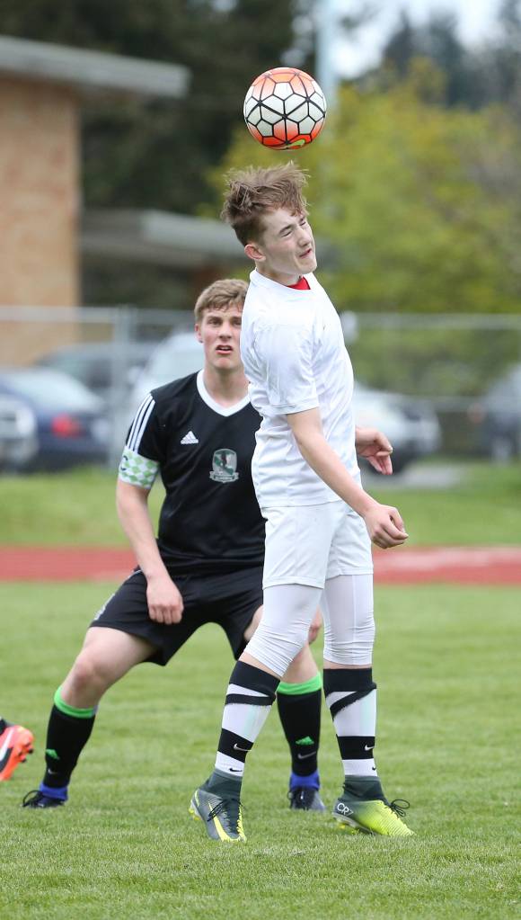 Ethan Spark advances the ball with a header. (Photo by John Fisken)