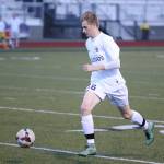 Kurtis Zylstra advances the ball for the Wildcats. Zylstra recorded a hat trick in the match. (Photo by John Fisken)