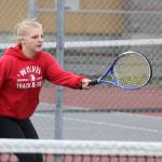 Avalon Renninger returns a shot in her second doubles win. (Photo by John Fisken)