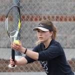 Valen Trujillo gets focused on a serve in first singles. (Photo by John Fisken)