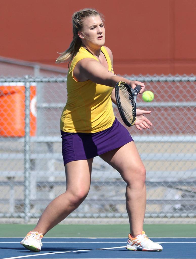 Peyton Carlson returns a shot in second singles. (Photo by John Fisken)