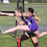 Kaitlyn Chelberg leaps to first in the 300 hurldes. (Photo by John Fisken)