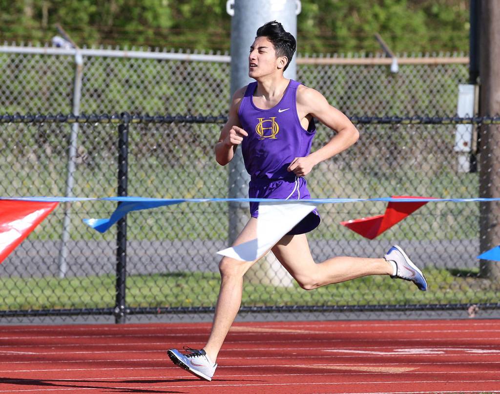 Mike Lym works for second place in the 800 meters. (Photo by John Fisken)