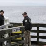 Photo by Ron Newberry/Whidbey News-Times                                Chief Ed Hartin, right, and firefighter Mike Matros with Central Whidbey Fire & Rescue prepare to lay boom around a vessel that was leaking hydraulic steering fluid while moored at the Coupeville Wharf Friday.