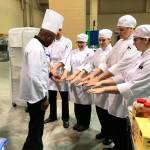 A judge checks the Oak Harbor culinary arts team for clean and sanitary hands at the ProStart National Invitational, which was held April 28-30 in Charleston, S.C. Oak Harbor placed 16th out of 48 teams. Photo courtesy Mary Arthur