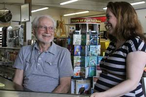 Eugene Phelps, owner of Gene&rsquo;s Art & Frame, in his Oak Harbor store Thursday, May 4, 2017 along with store manager Linnane Armstrong. Phelps has been in business for 50 years. The store is celebrating its 50th anniversary in June. Photo by Ron Newberry/Whidbey News-Times.