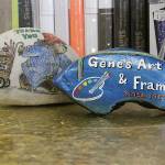 Whidbey Island Rocks provided some colorfully-painted decor for the front counter of Gene&rsquo;s Art & Frame. The store partners with the popular club. Phelps built the store&rsquo;s glittery gold countertop. Photo by Ron Newberr/Whidbey News-Times
