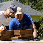 Jordan Schisel, left, determines the length of a cut during the Central Whidbey Hearts & Hammers&rsquo; annual work day Saturday, May 6, 2017 in Coupeville. The volunteer nonprofit group participated in 18 different projects to help their Central Whidbey neighbors Saturday. Photo by Ron Newberry/Whidbey News-Times