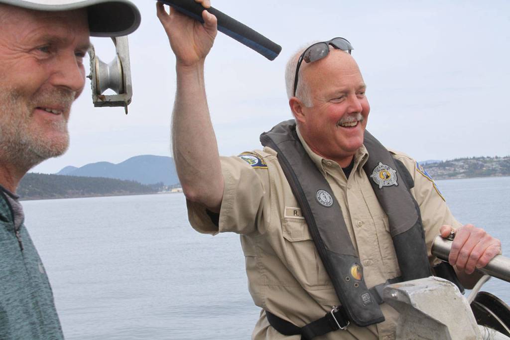 Ralph Downes, enforcement officer with Washington Department of Fish and Wildlife, shares a light moment with commercial shrimper Stuart Ford Wednesday, May 10, 2017, while out on patrol. Downes has known Stuart for more than 20 years. Photo by Ron Newberry/Whidbey News-Times