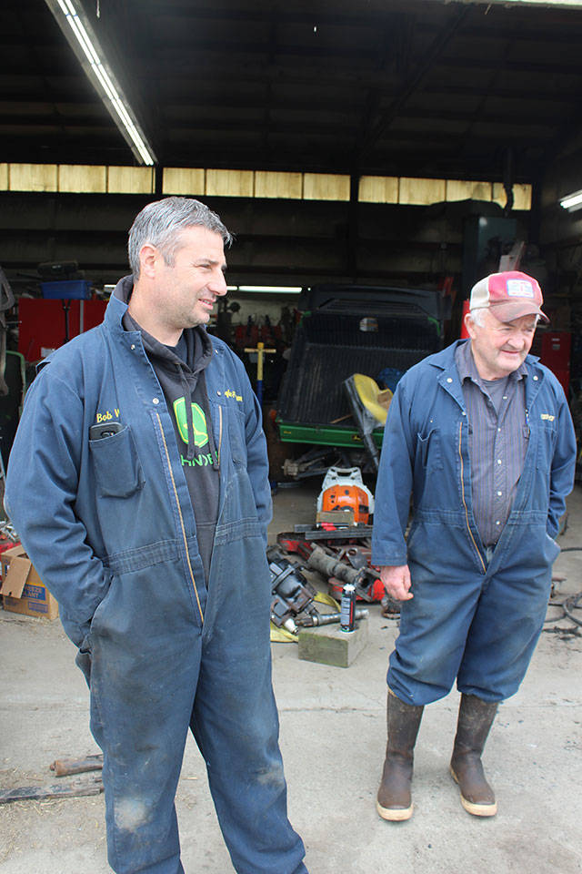 Bob Engle, left, and his uncle, Len Engle, at the garage on the grounds of the former dairy farm and homestead. The Engle family, farmers since the 1850s, switched to raising beef cattle about six years ago.