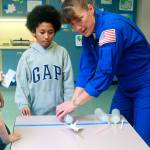 NASA Astronaut Heide Stefanyshyn-Piper leads fourth-grader Keon Hylton, center, in a rocket-launching game Friday at Hillcrest Elementary&rsquo;s first STEM Family Night. Photo by Daniel Warn/Whidbey News-Times