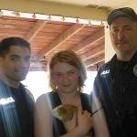 Oak Harbor police officers Jeremy Andreano, left, and Pat Horn pose with Anastasia Drake and her new guinea pig, Sirius, Sunday, May 21, 2017. Photo courtesy LaCinda Drake