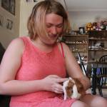 Anastasia Drake is tickled with her a new guinea pig, Sirius, at her Oak Harbor home Monday, May 22, 2017. Drake was distraught over the weekend after her longtime guinea pig Spice died. The Oak Harbor police brought her a new one to cheer her up. Photo by Ron Newberry/Whidbey News-Times.