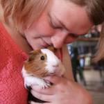 Anastasia Drake is tickled with her a new guinea pig, Sirius, at her Oak Harbor home Monday, May 22, 2017. Drake was distraught over the weekend after her longtime guinea pig Spice died. The Oak Harbor police brought her a new one to cheer her up. Photo by Ron Newberry/Whidbey News-Times.