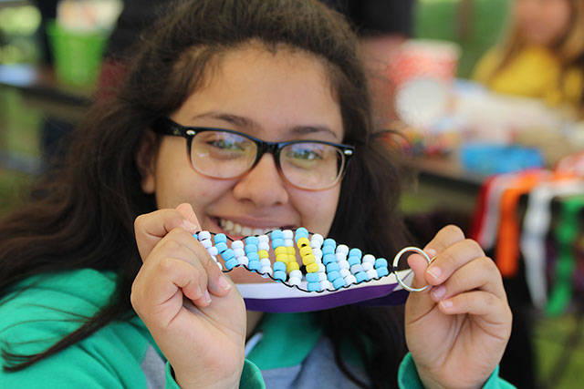 Nanci Melendrez, 15, shows off the fish she made at the children&rsquo;s activities tent while helping her sister and other kids.