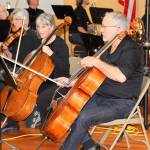 Saratoga Orchestra cellists Norma Dermond, left, and James Smith play with the rest of the strings section as part of &ldquo;Link Up: The Orchestra Rocks,&rdquo; a Carnegie Hall program that pairs elementary schools with orchestras for collaboration and education. Photo by Daniel Warn/Whidbey News-Times