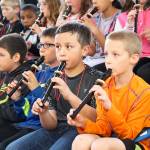From left, Jaeden Altheiser, Carlos Orozco, Mason Burns, William Greiger and Jacob Ward play recorders to accompany the Saratoga Orchestra Wednesday at Oak Harbor Elementary. Third and fourth grade students from Broad View Elementary, Oak Harbor Elementary and Hillcrest Elementary took part in the &ldquo;Link Up: The Orchestra Rocks&rdquo; concert. Photo by Daniel Warn/Whidbey News-Times