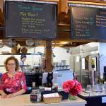Michele Lynn works behind the counter of her new restaurant The Cove Cafe, located inside the Coupeville Wharf. Photo by Megan Hansen/Whidbey News-Times