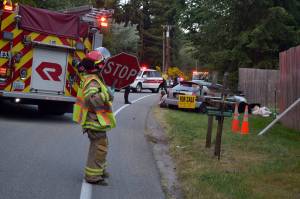 Kyle Jensen / The Record &mdash; A South Whidbey Fire/EMS responder blocks the scene of the wreckage Monday night. The collision left a Lake Stevens woman dead and a Clinton man in Island County Jail.
