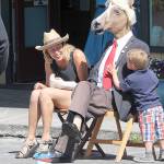 Three-year-old Tate Phillips, plays peek-a-boo with a Memorial Day Parade-goer Saturday in Coupeville. Photo by Daniel Warn/Whidbey News-Times