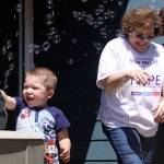 Jackson Young, 3, tries out the bubble machine while Mary Brock, center, and Wendy Hermandorfer try to stand clear of the bubbles Sunday at Karla Sharkey&rsquo;s house in Oak Harbor Sunday. The group met for some final preparations for Relay for Life of Whidbey Island, which starts at 6 p.m. Friday. The bubbles will glow in the dark after Friday night&rsquo;s luminary ceremony. Photo by Ron Newberry/Whidbey News-Times