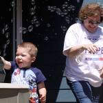 Jackson Young, 3, tries out the bubble machine while Mary Brock, center, and Wendy Hermandorfer try to stand clear of the bubbles at Karla Sharkey&rsquo;s house in Oak Harbor Sunday. The group met for some final preparations for Relay for Life of Whidbey Island, which starts at 6 p.m. Friday. The bubbles will glow in the dark after Friday night&rsquo;s luminary ceremony. Photo by Ron Newberry/Whidbey News-Times