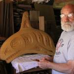 Jim Short stands before a wood carving Friday, May 26, 2017, in his Coupeville shop. The carving will be part of a whale bell that is coming to the Coupeville Wharf. An unveiling celebration will take place at 3:30 p.m. Saturday, June 3. Photo by Ron Newberry/Whidbey News-Times